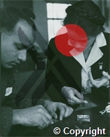 Dr E Petersen, a Dane, holds a pricked finge for Dr Syed Ghousuddin to make a blood slide