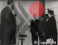 Visitors and students being shown a slip lamp in the Hospital for Tropical Diseases by Mr Langley