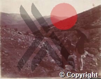 Photograph of Ross holding a camera and another man with an umbrella at El Raso del Conejo