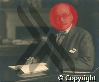 Ross at desk holding pen